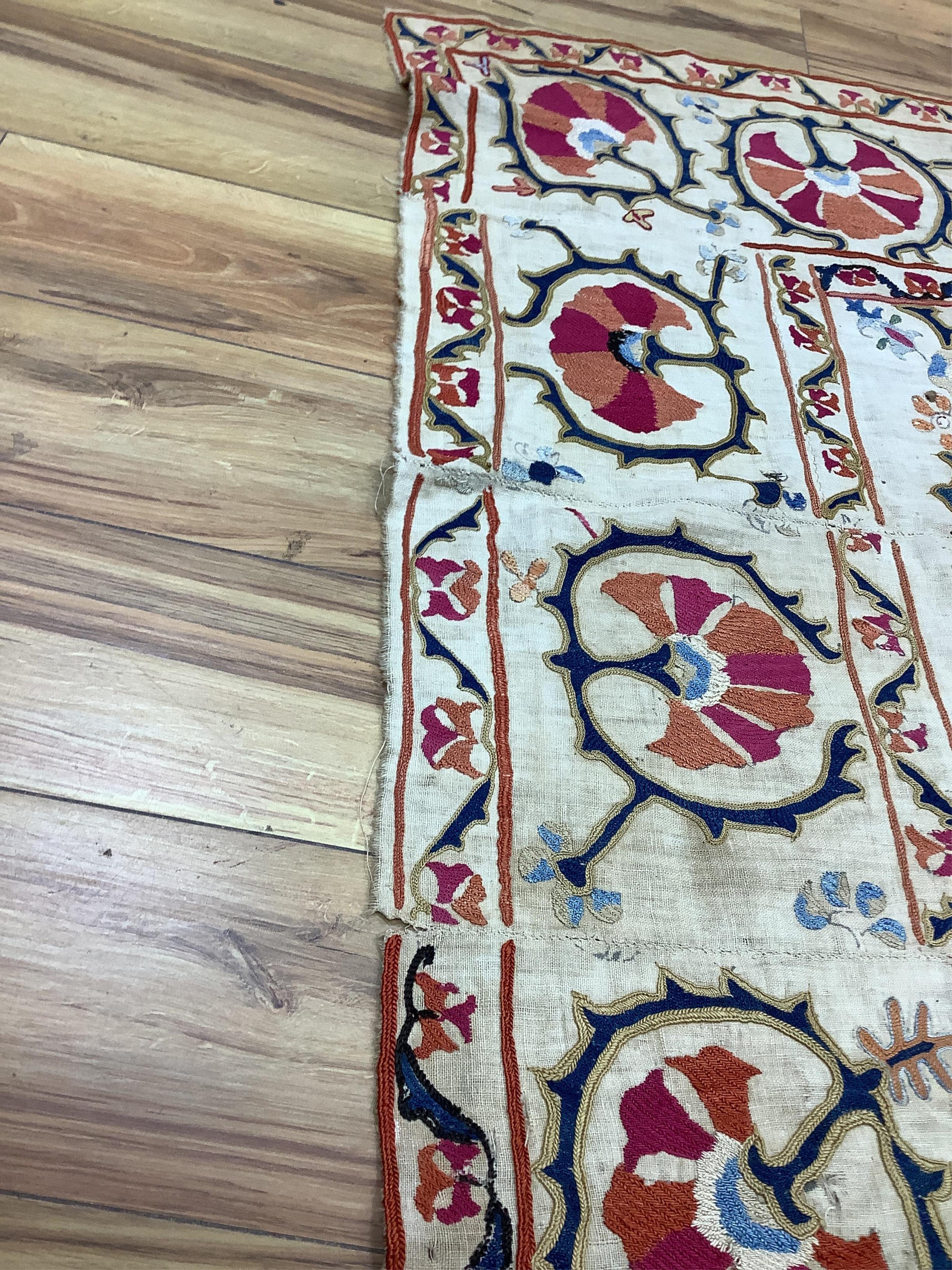 A 19th century Uzbekistan Suzani, hand embroidered hanging. Made from hand woven linen panels each approximately 28cm wide x 167cm long. Hand embroidered with silk hand dyed threads, in orange, red, blue and yellows, usi